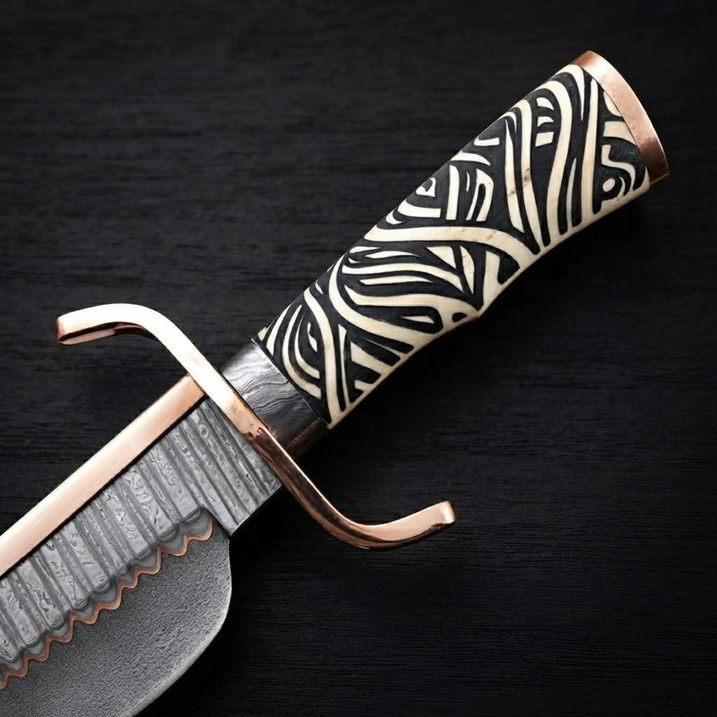 Close-up view of a 12-inch Musso-style Bowie knife showing a carved black-and-white patterned handle, copper double crossguard, and copper Damascus steel blade detailing on a black wood background.