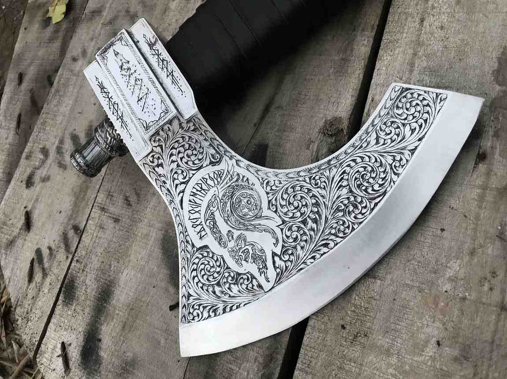 Complete view of a unique hand-engraved Viking axe resting on a rustic wooden pallet, showcasing its artistic Norse blade design