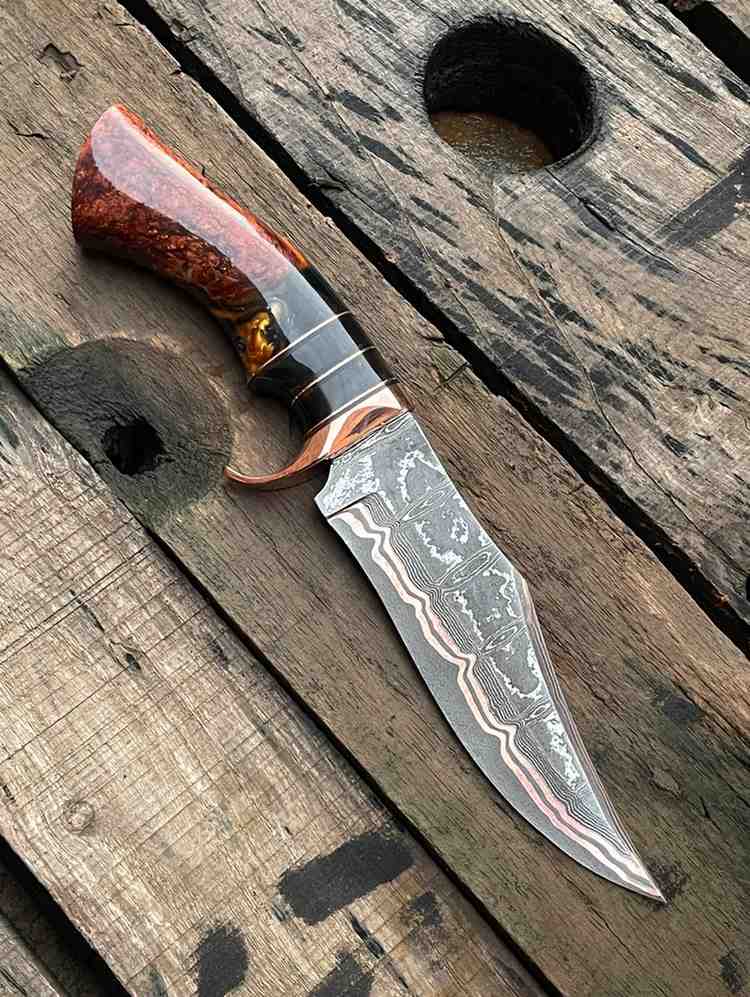 Custom-made Bowie knife with unique Copper Damascus steel pattern and artistic resin grip