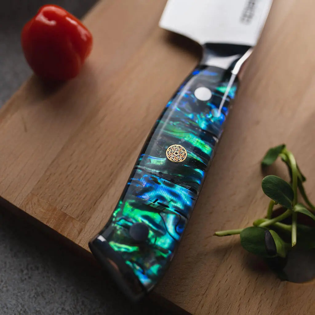 Abalone shell resin handle on an Awabi Damascus chef knife