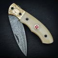 Hand forged Damascus drop point folding knife with camel bone handle