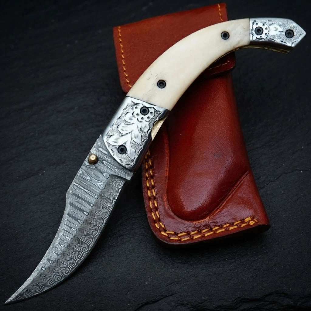 Hand forged Damascus folding knife with camel bone handle