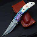 Hand forged Damascus drop point folding knife with camel bone handle