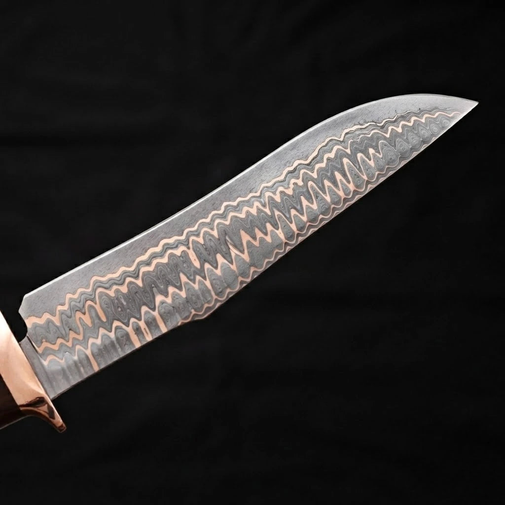 Close-up view of a Bowie knife blade showcasing its intricate layered wave Copper Damascus steel pattern against a black background.