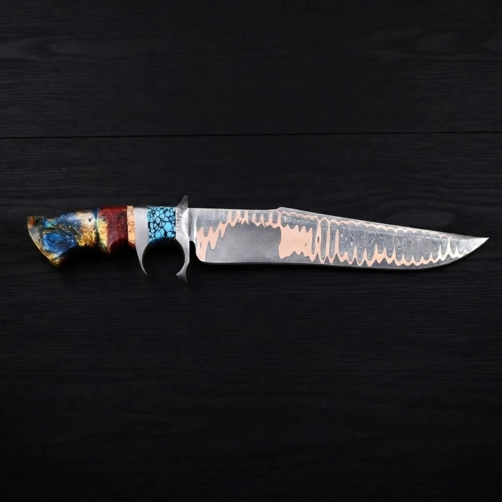 Horizontal profile view of a Copper Damascus Bowie knife with a steel double guard, turquoise stone accent, and multi-colored resin handle on a dark wood background.