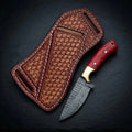 Damascus steel cowboy knife with red stone-style handle and solid brass bolster