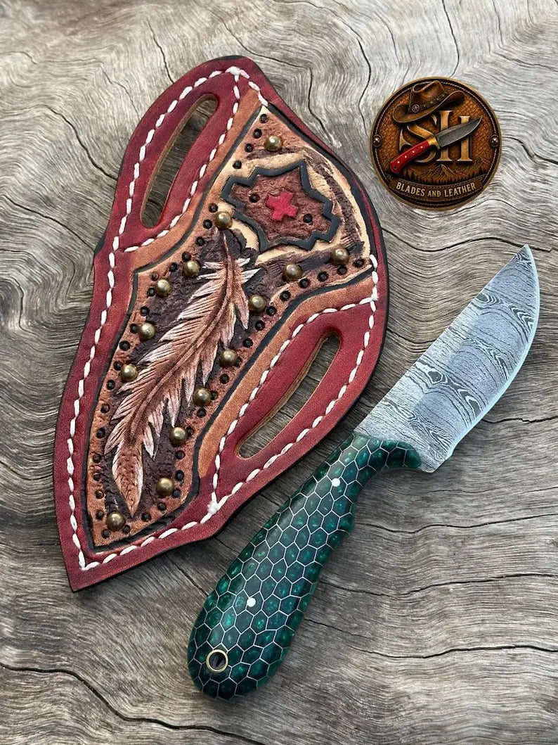 Damascus cowboy skinner knife with resin and steel handle and hand-stitched leather sheath