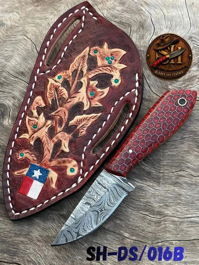 Damascus skinner knife shown with its genuine leather sheath
