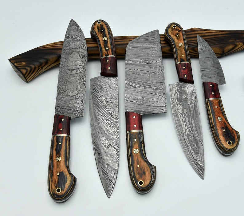 5-piece Damascus steel kitchen knife set featuring two-tone resin wood handles with mosaic pins, displayed against a white background with a dark wooden accent bar