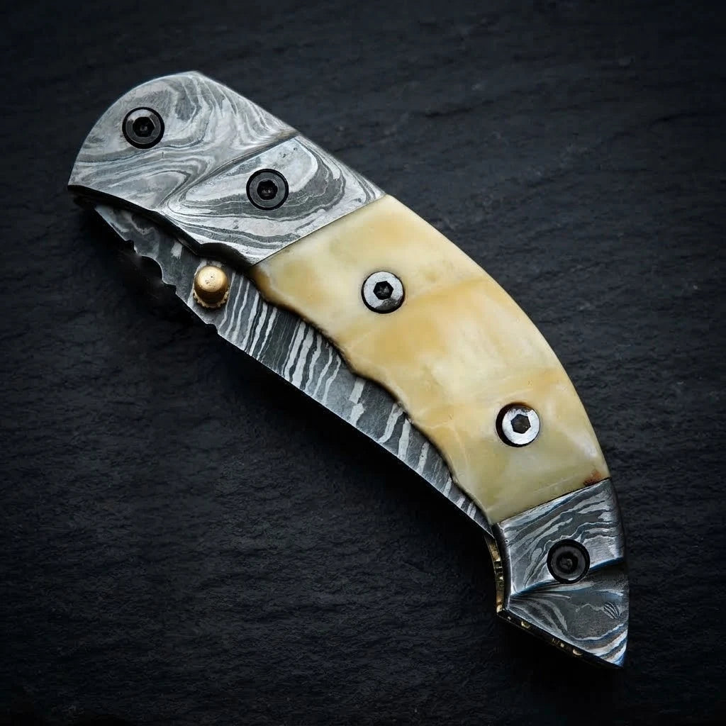 Camel bone handle folding knife — Damascus steel blade close-up