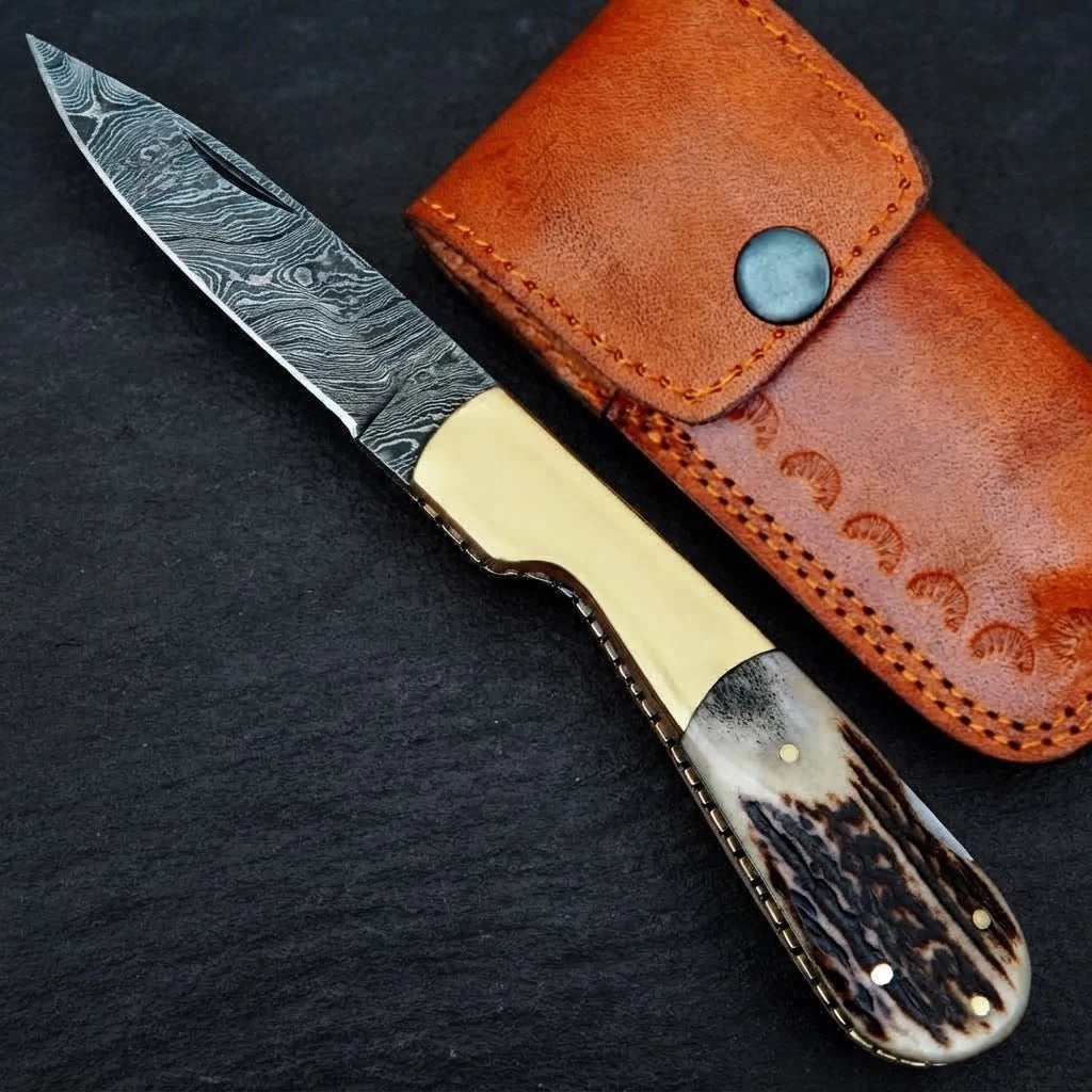 Damascus steel folding knife with stag horn handle