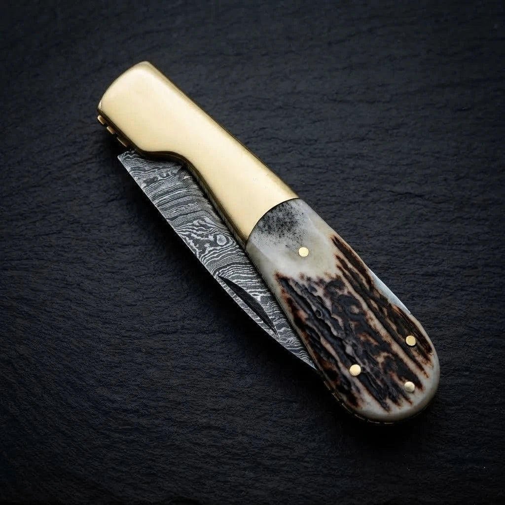 Stag horn handle Damascus folding knife — blade close-up