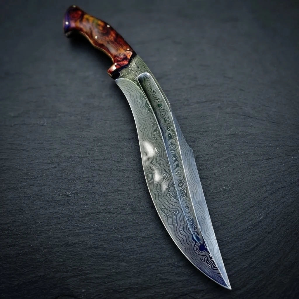 Curved full tang Damascus steel Kukri knife with distinct wavy blade patterns and a reddish-brown rosewood handle, lying on a dark slate surface