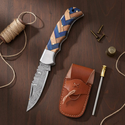 Handmade Damascus steel pocket knife with olive wood and blue wood handle - blade and Damascus steel pattern close-up