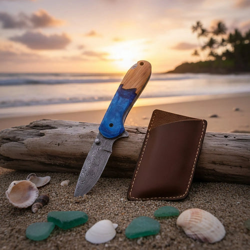 Handmade Damascus steel pocket knife with olive wood and resin handle - blade and Damascus steel pattern close-up