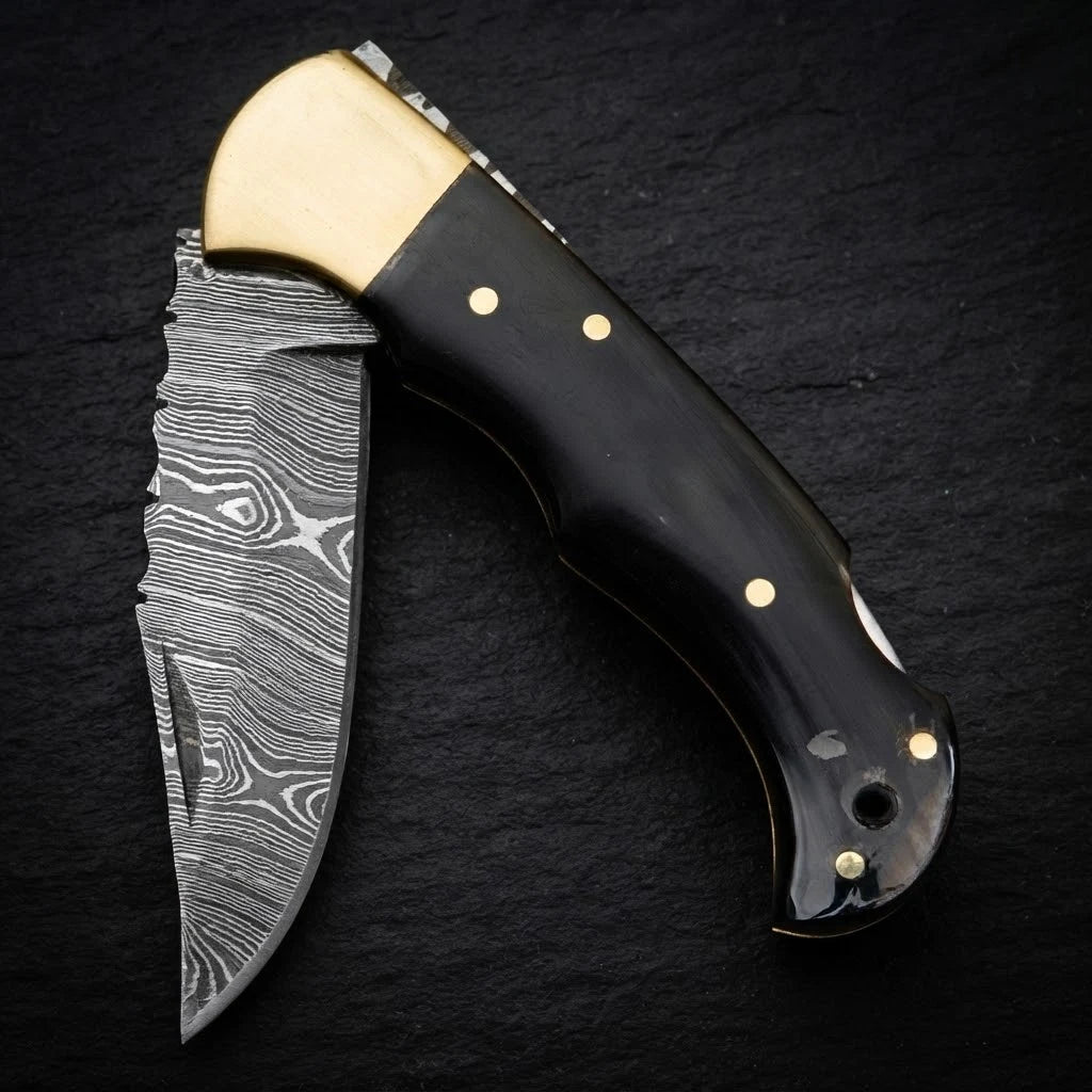 Damascus EDC folding knife with buffalo horn handle and brass bolster – folded with sheath