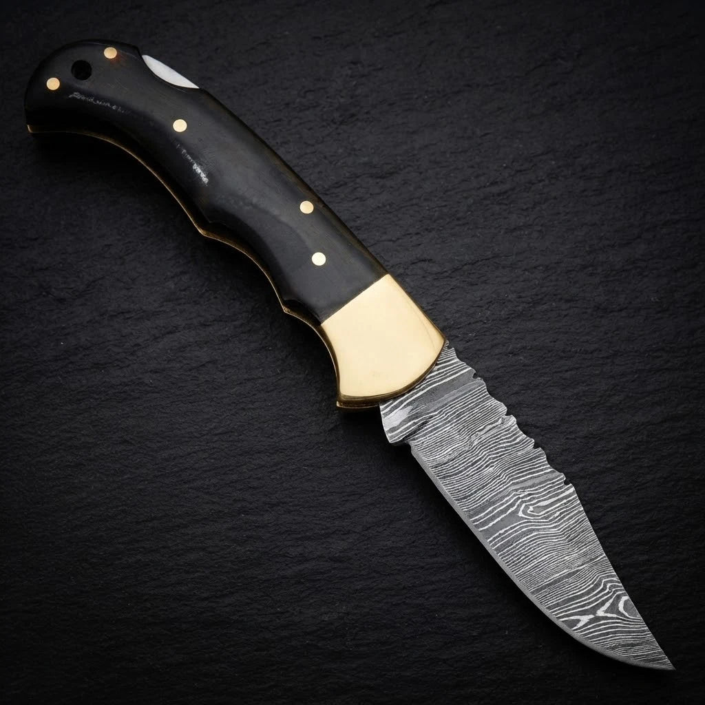 Damascus EDC folding knife with buffalo horn handle and brass bolster – handle detail