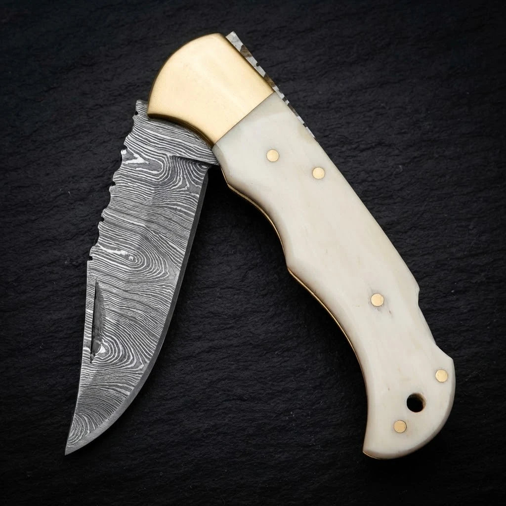 Damascus EDC folding knife with camel bone handle and brass bolster – blade close-up