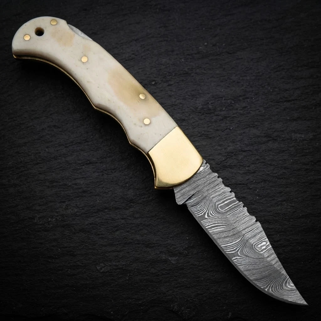 Damascus EDC folding knife with camel bone handle and brass bolster – folded with sheath