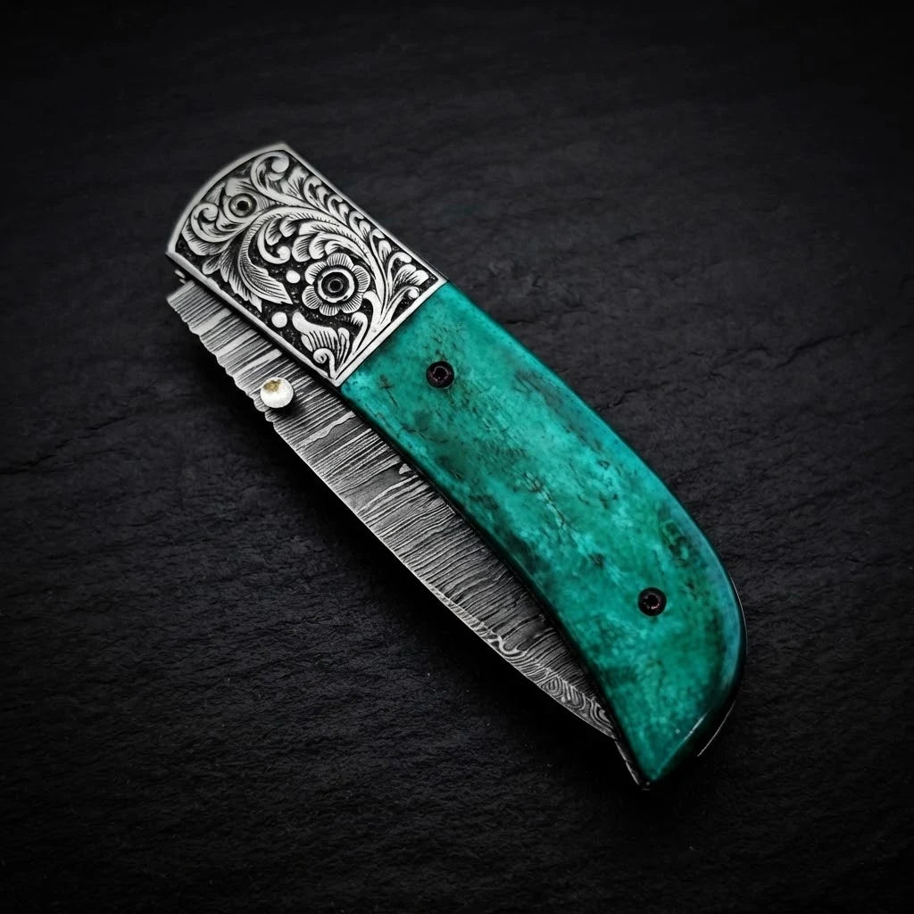 Damascus folding knife with green camel bone handle and steel bolster – folded with sheath