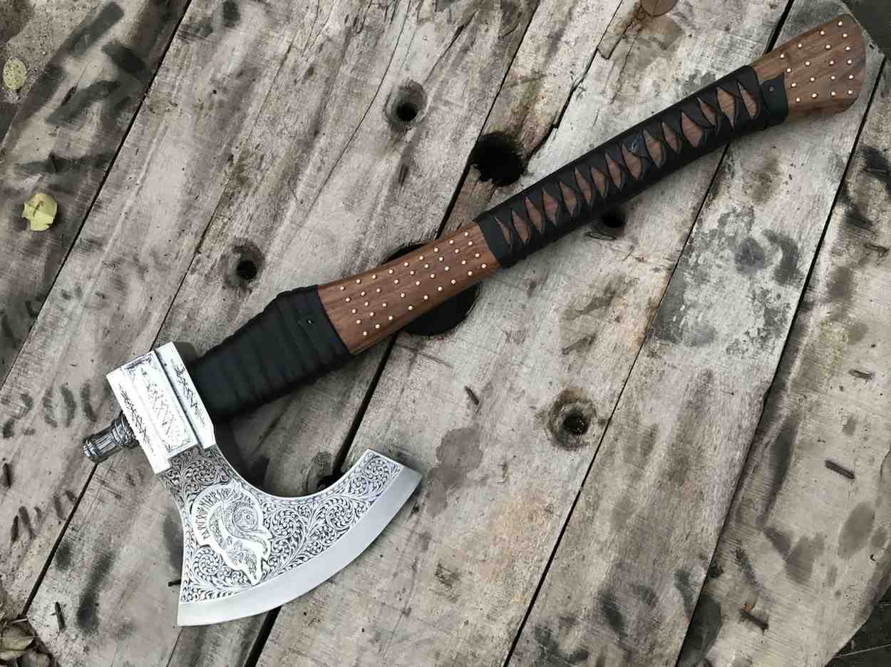 Authentic handcrafted Viking battle axe with unique hand-etched designs, suitable for historical display or collection.