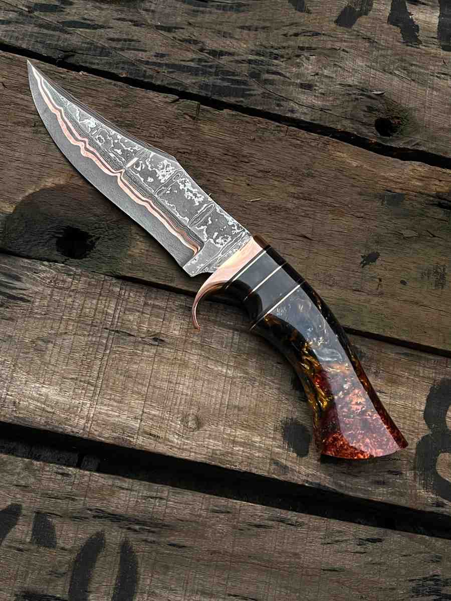 Custom-made Bowie knife with unique Copper Damascus steel pattern and artistic resin grip