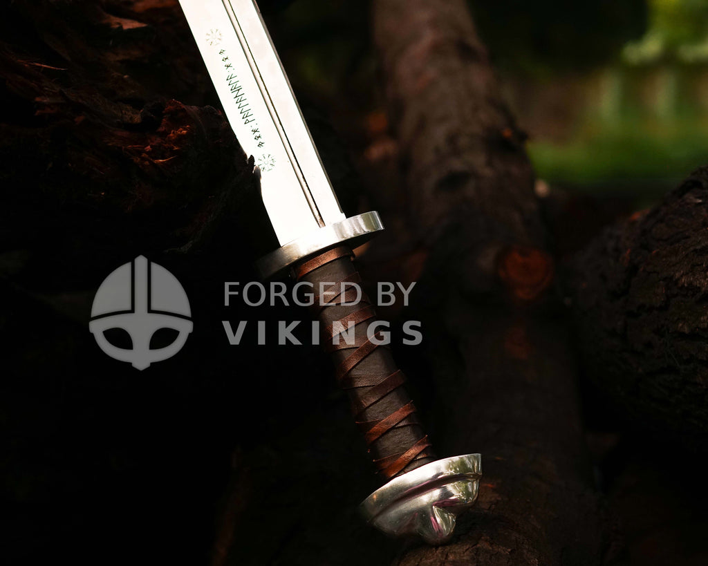 High-detail shot of custom Viking Seax grip with authentic leather wrapping and steel crossguard.