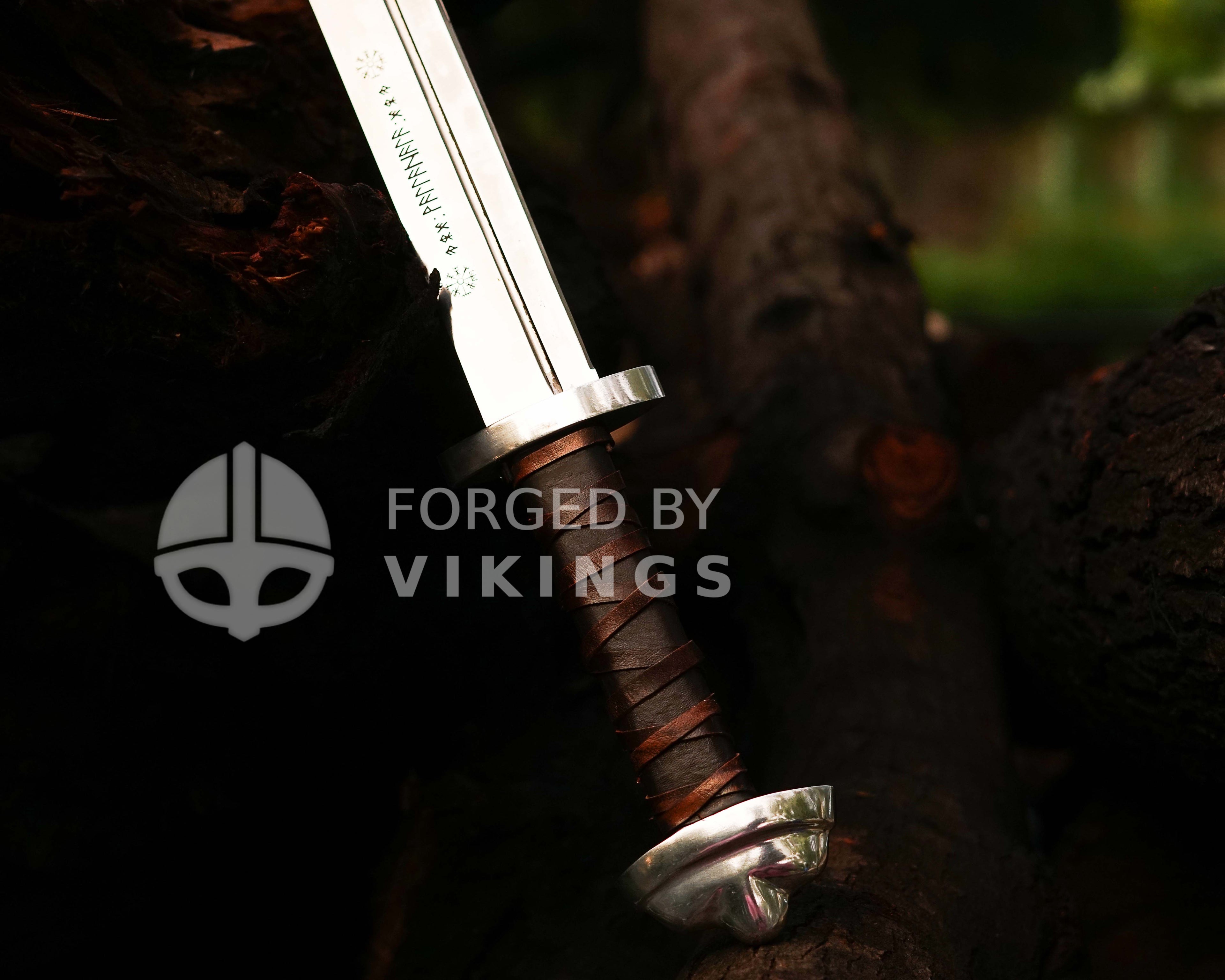 High-detail shot of custom Viking Seax grip with authentic leather wrapping and steel crossguard.
