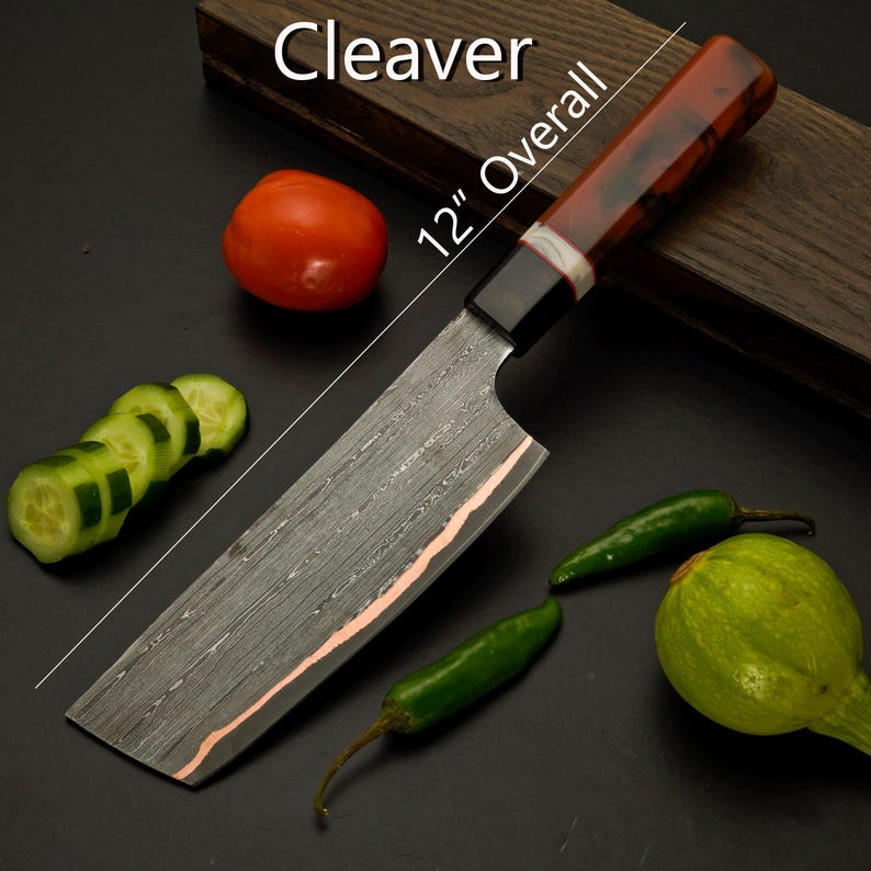 Handmade copper Damascus chef knife set laid out with its leather knife bag