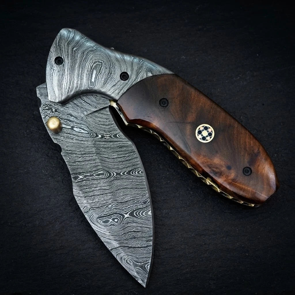 Handmade Damascus folding knife with rosewood handle and Damascus bolster – blade close-up