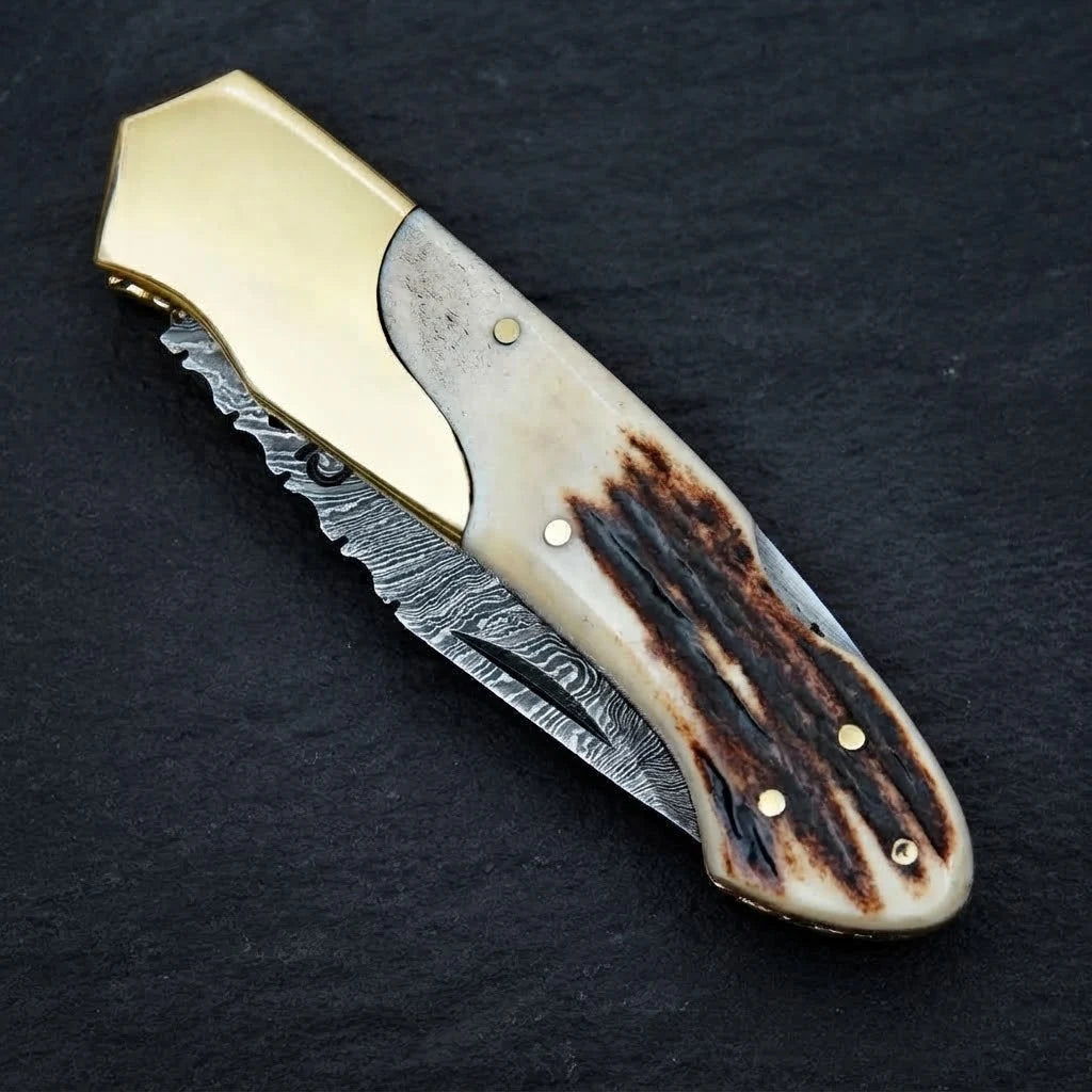 Stag horn handle folding knife — Damascus steel blade close-up