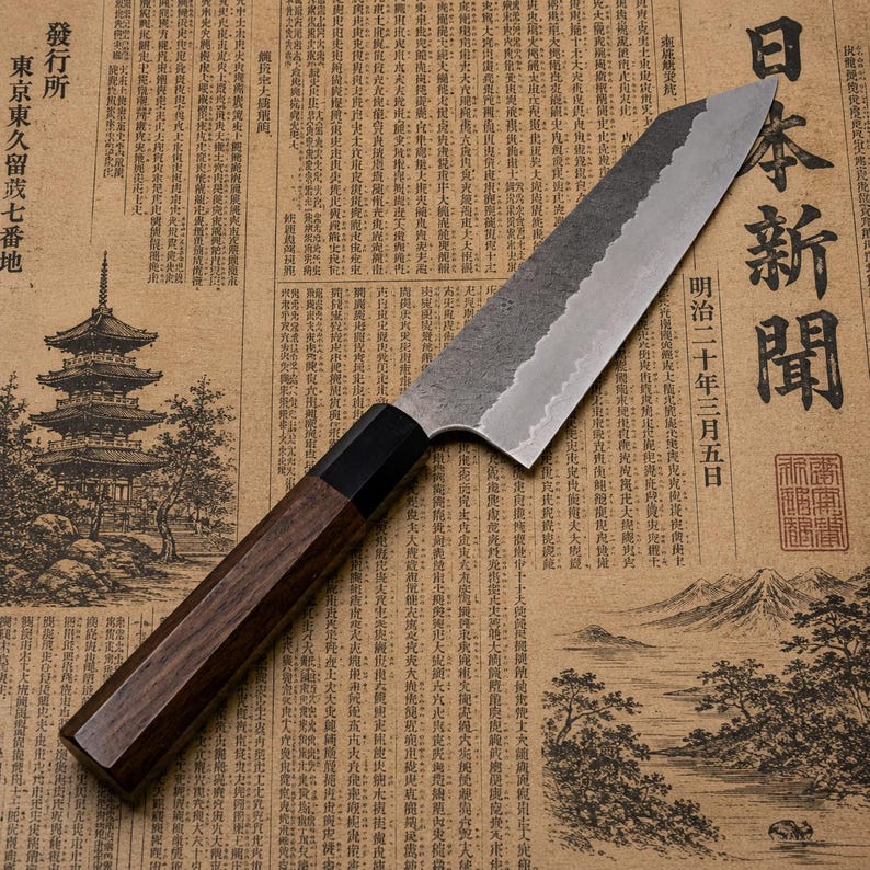 Layered carbon steel and stainless steel blade of a handmade Japanese-style chef knife