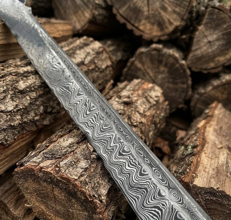 Close-up of the Woodland Falchion's Damascus steel blade pattern