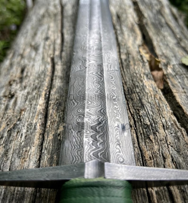 Green leather-wrapped grip detail on the Woodland Falchion