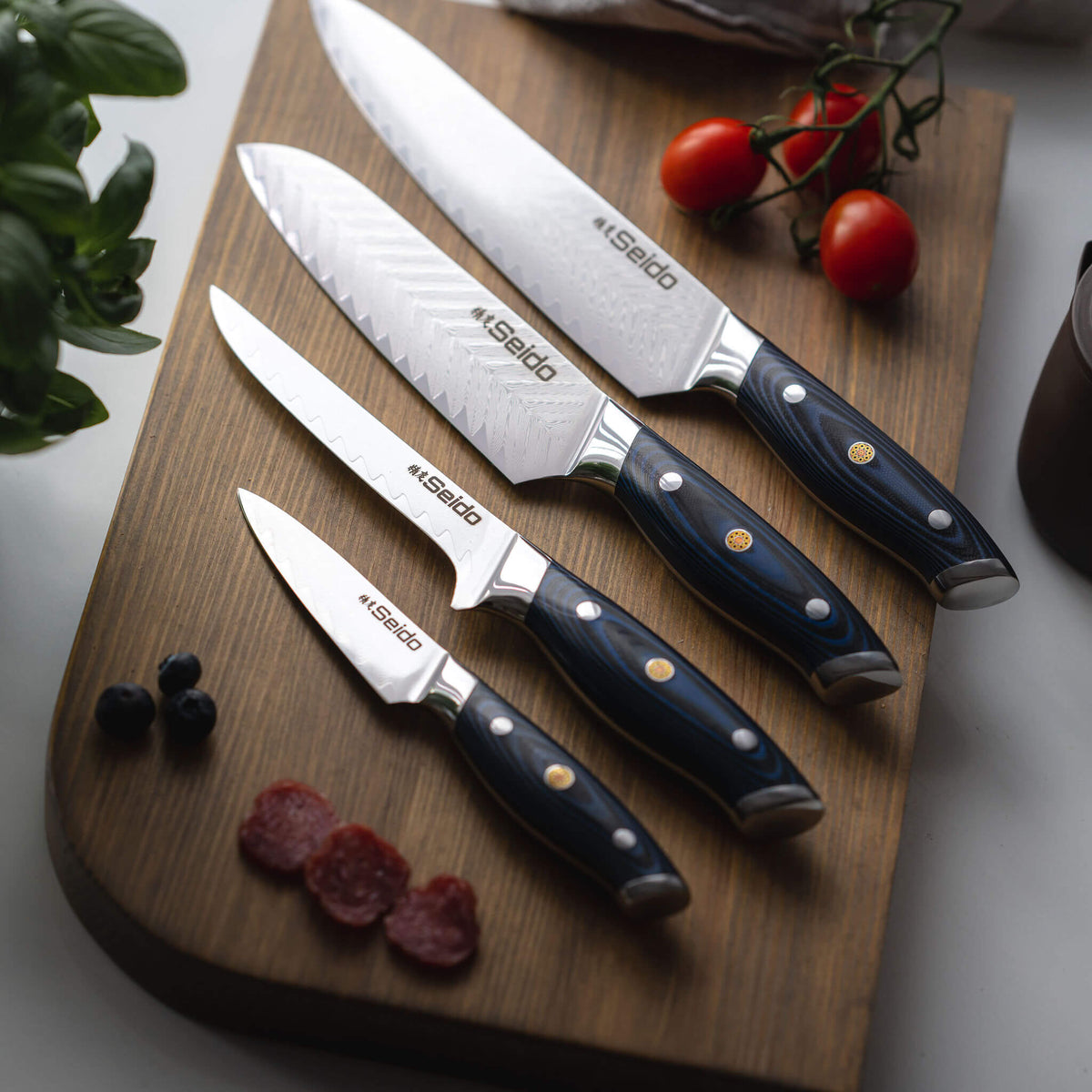 Blue plum wood and G10 handle on a Kanpeki Damascus knife