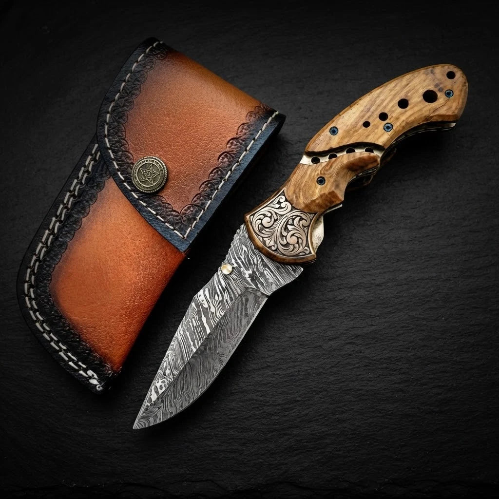 Damascus folding knife with olive burl wood handle – blade close-up