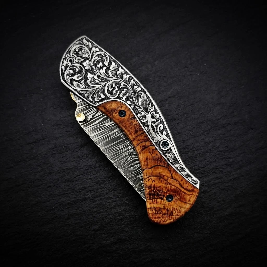 Olive wood folding pocket knife — handle grain and bolster detail