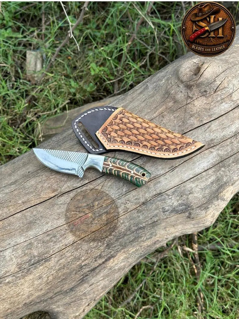 Small horse rasp skinner knife with pinecone resin handle and steel bolster