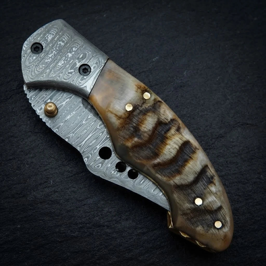 Hand forged Damascus drop point folding knife with ram horn handle