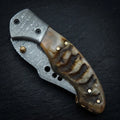 Hand forged Damascus drop point folding knife with ram horn handle