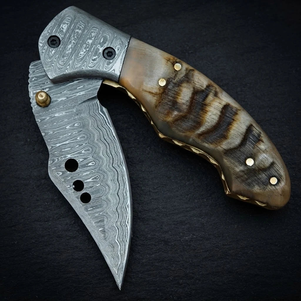 Damascus drop point folding knife — 156-layer blade pattern close-up