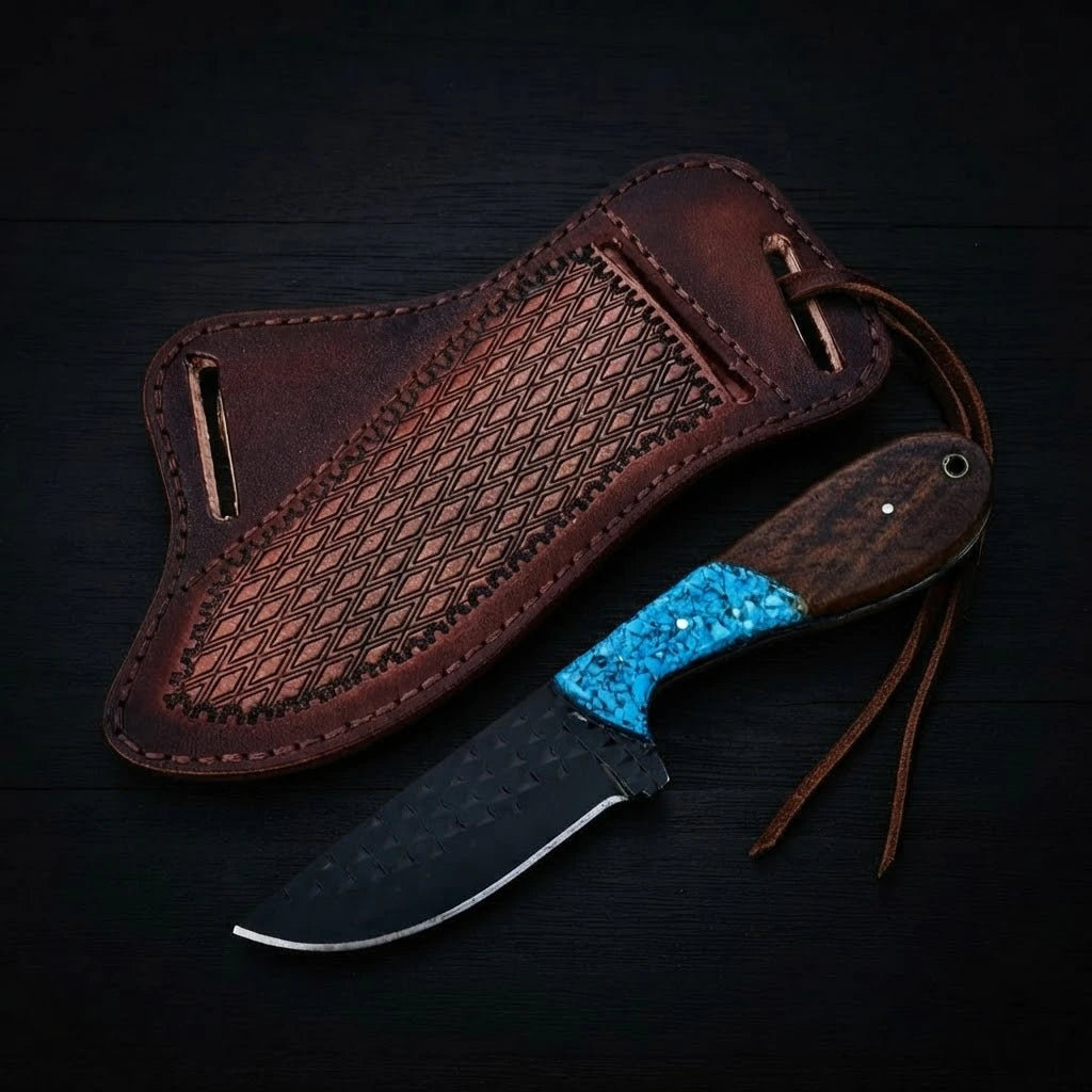 Handmade Buckaroo ranch knife crafted from dark forged rasp steel with a hybrid turquoise inlay and wood handle, shown with a textured brown leather pancake sheath on a dark wood background