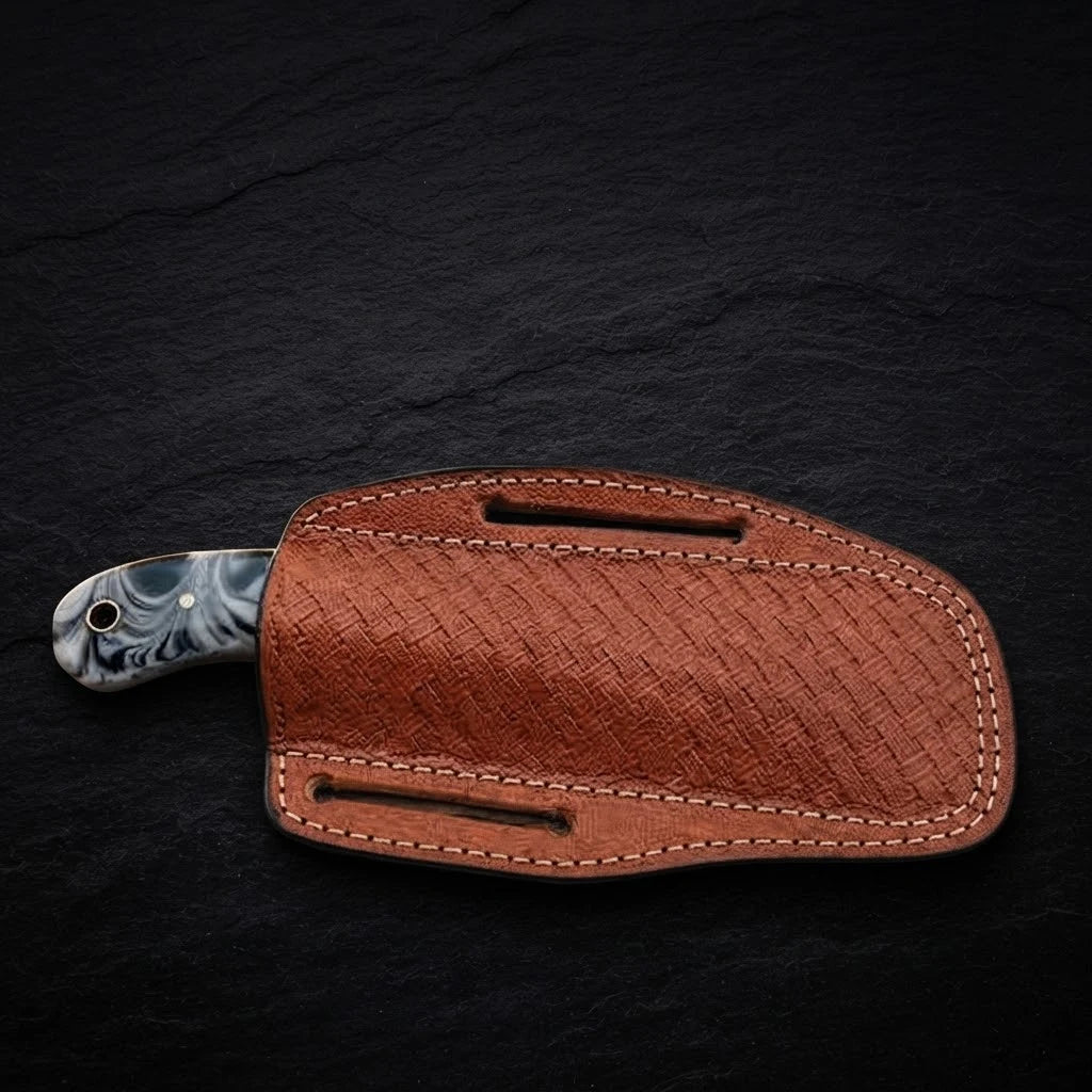 Close-up of Redstone Damascus steel blade pattern on cowboy bull cutter knife