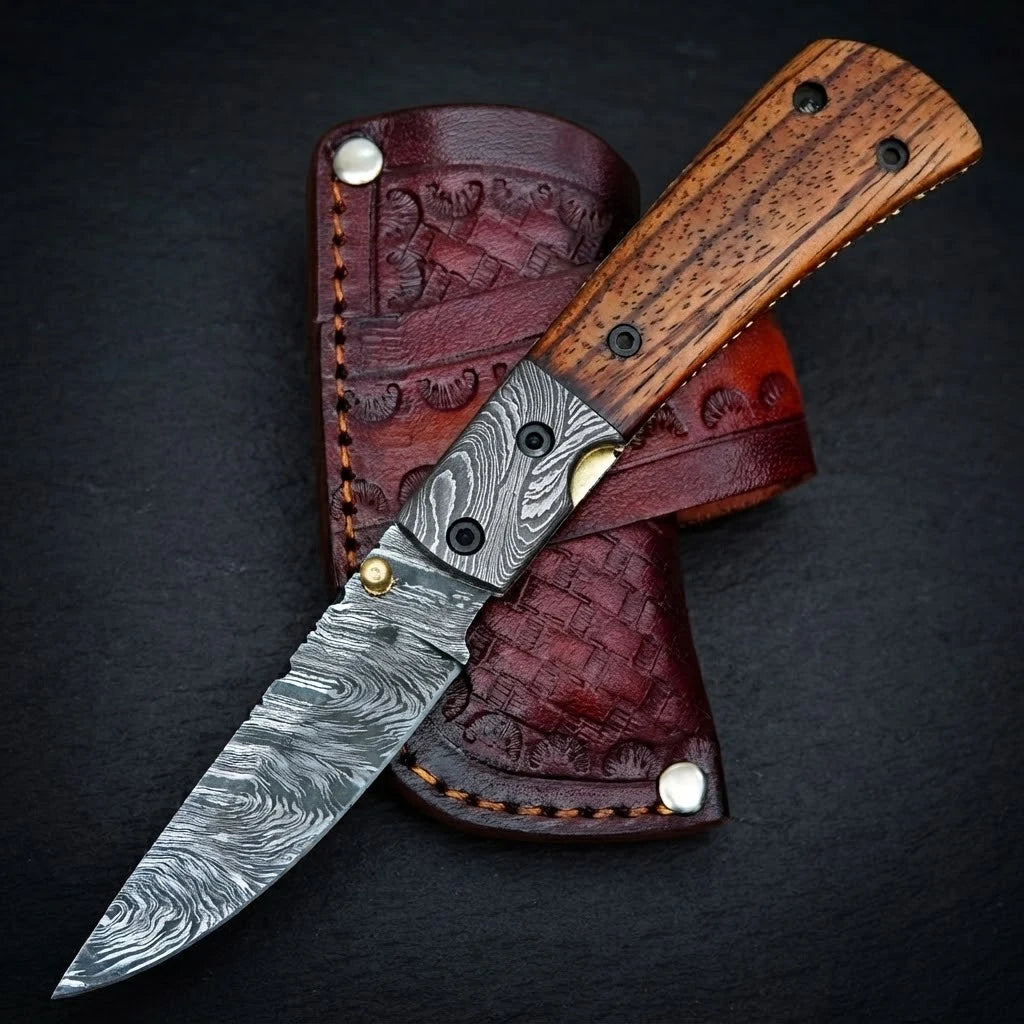 Damascus folding knife — sabre grind blade profile