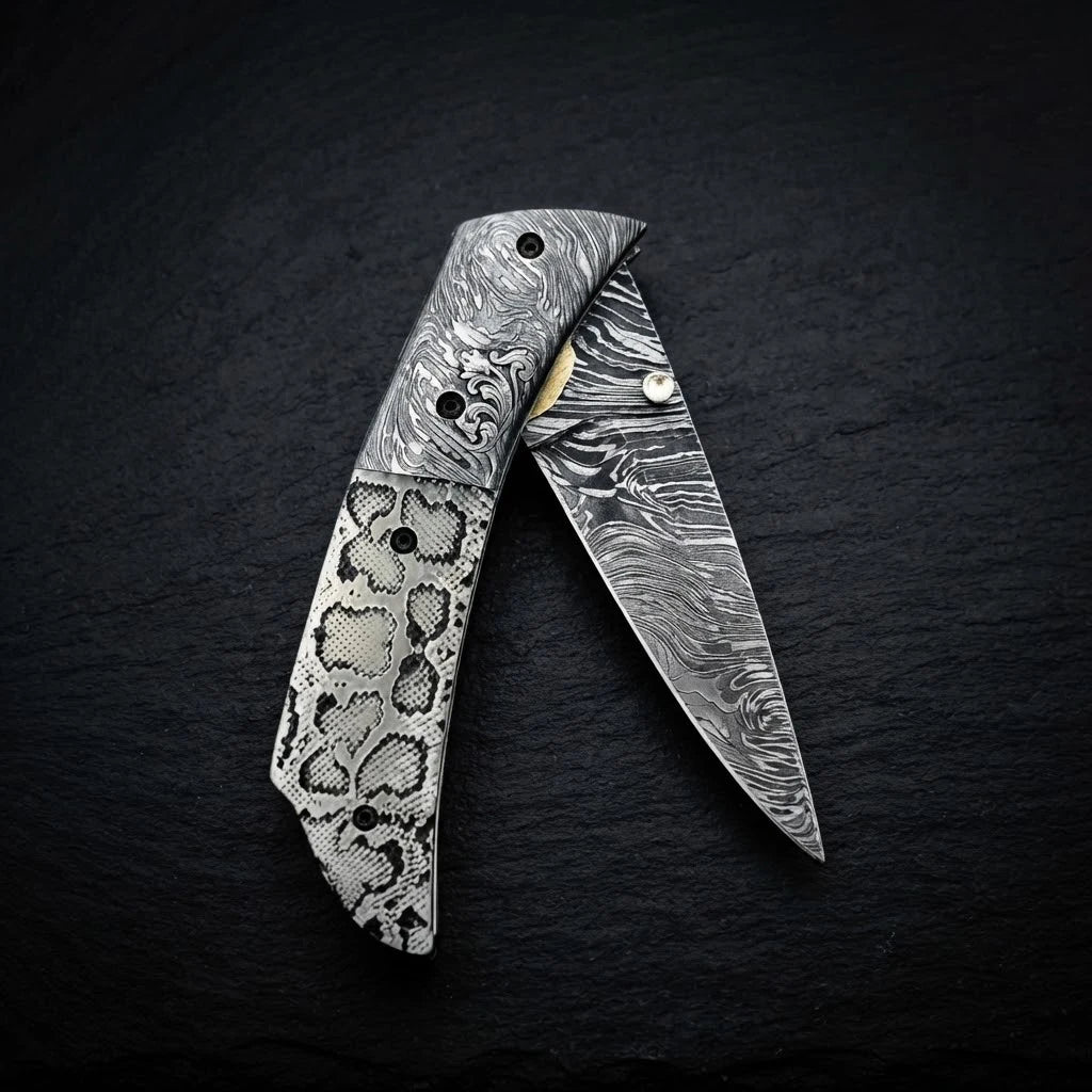 Scrimshaw camel bone folding knife with Damascus bolster and drop point blade – blade close-up