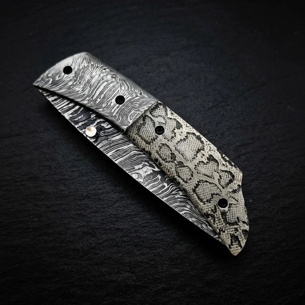 Scrimshaw camel bone folding knife with Damascus bolster and drop point blade – handle detail