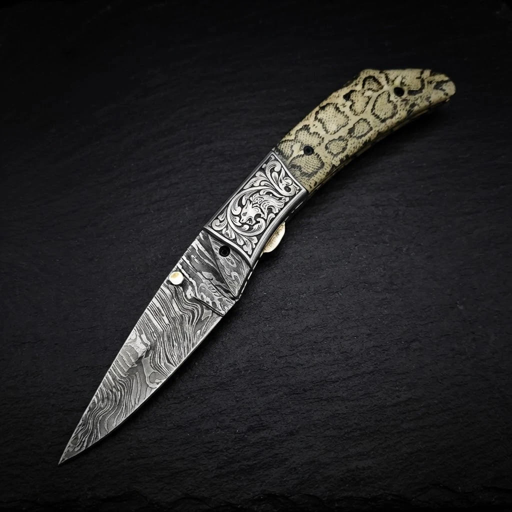 Scrimshaw camel bone folding knife with Damascus bolster and drop point blade – with leather sheath