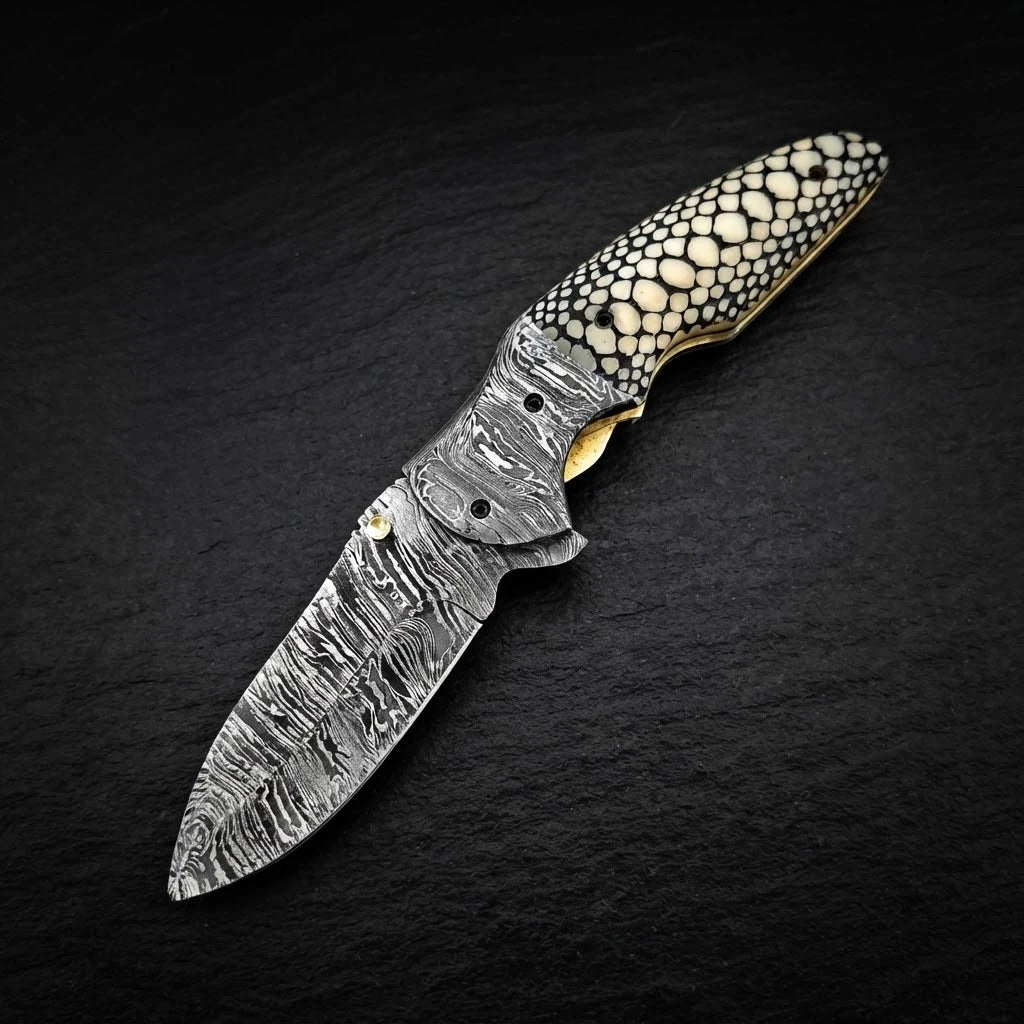 Scrimshaw camel bone folding pocket knife — drop point blade and bolster detail