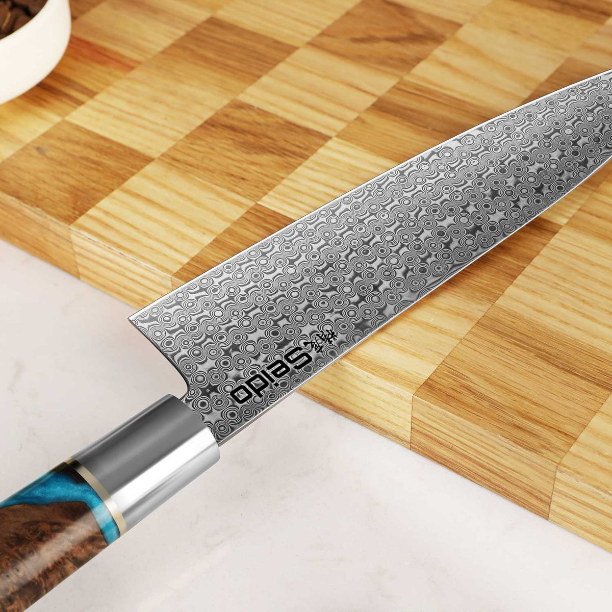 Shinko gyuto Japanese chef knife showing AUS-10 and VG-10 Damascus ripple pattern
