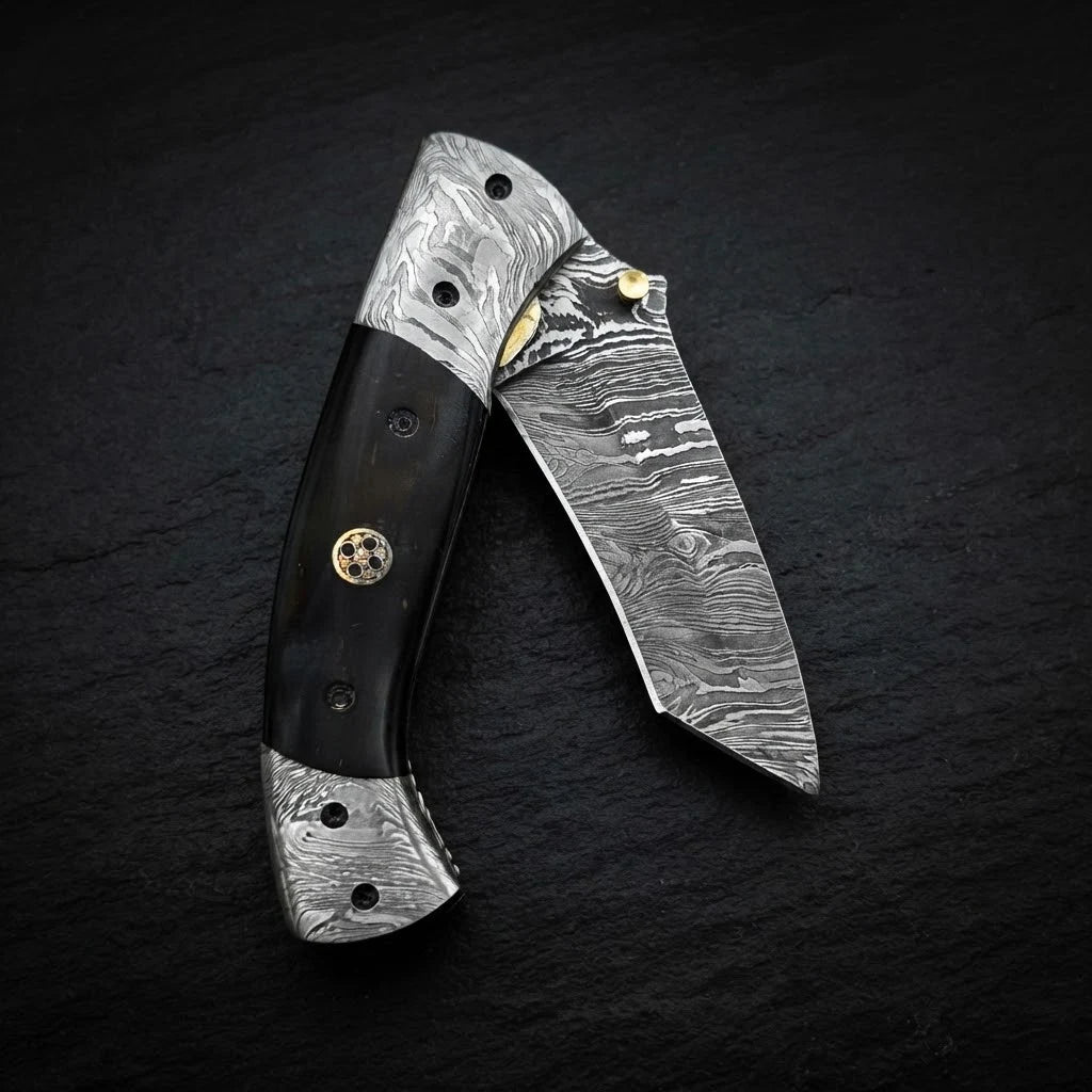 Damascus tanto folding knife with camel bone handle and double Damascus bolster – blade close-up